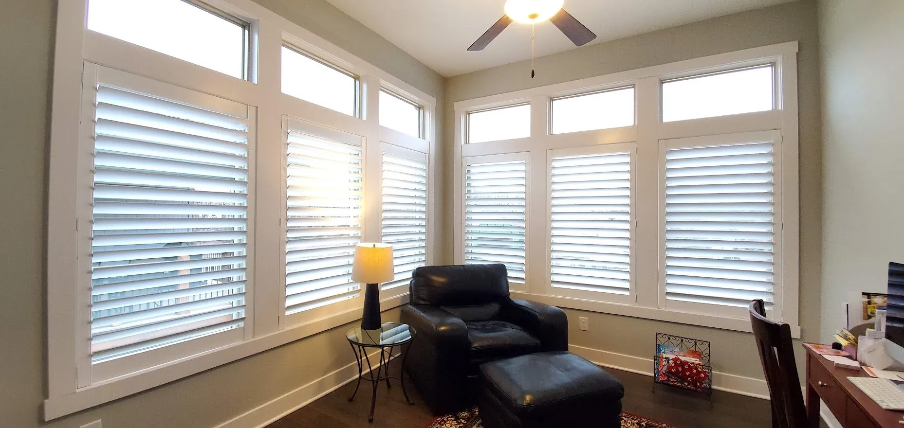 Sunlit room with large white plantation shutters