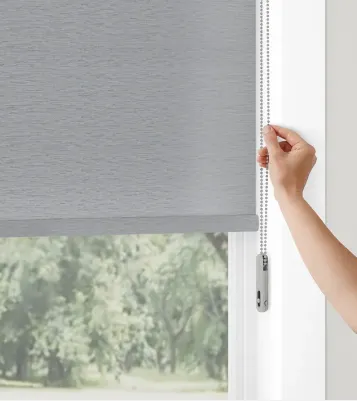 Hand adjusting gray window roller blind chain.