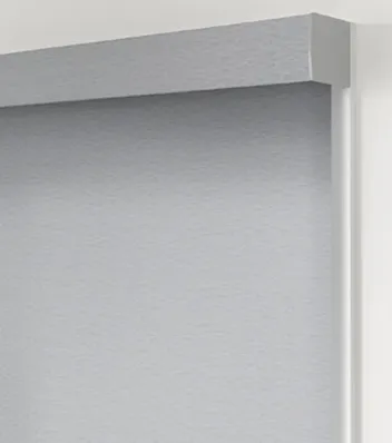 Gray roller blind on white wall