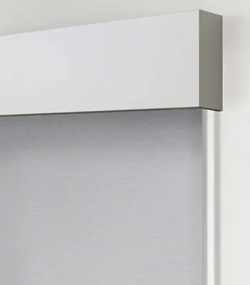 Gray roller shade with metal casing on wall.