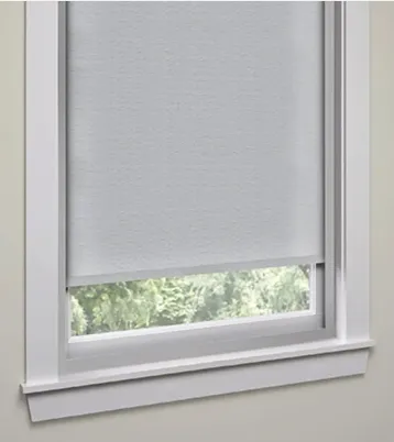 White roller shade partially open on window