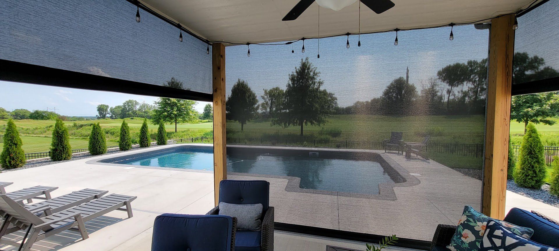 Outdoor pool area with greenery and shades
