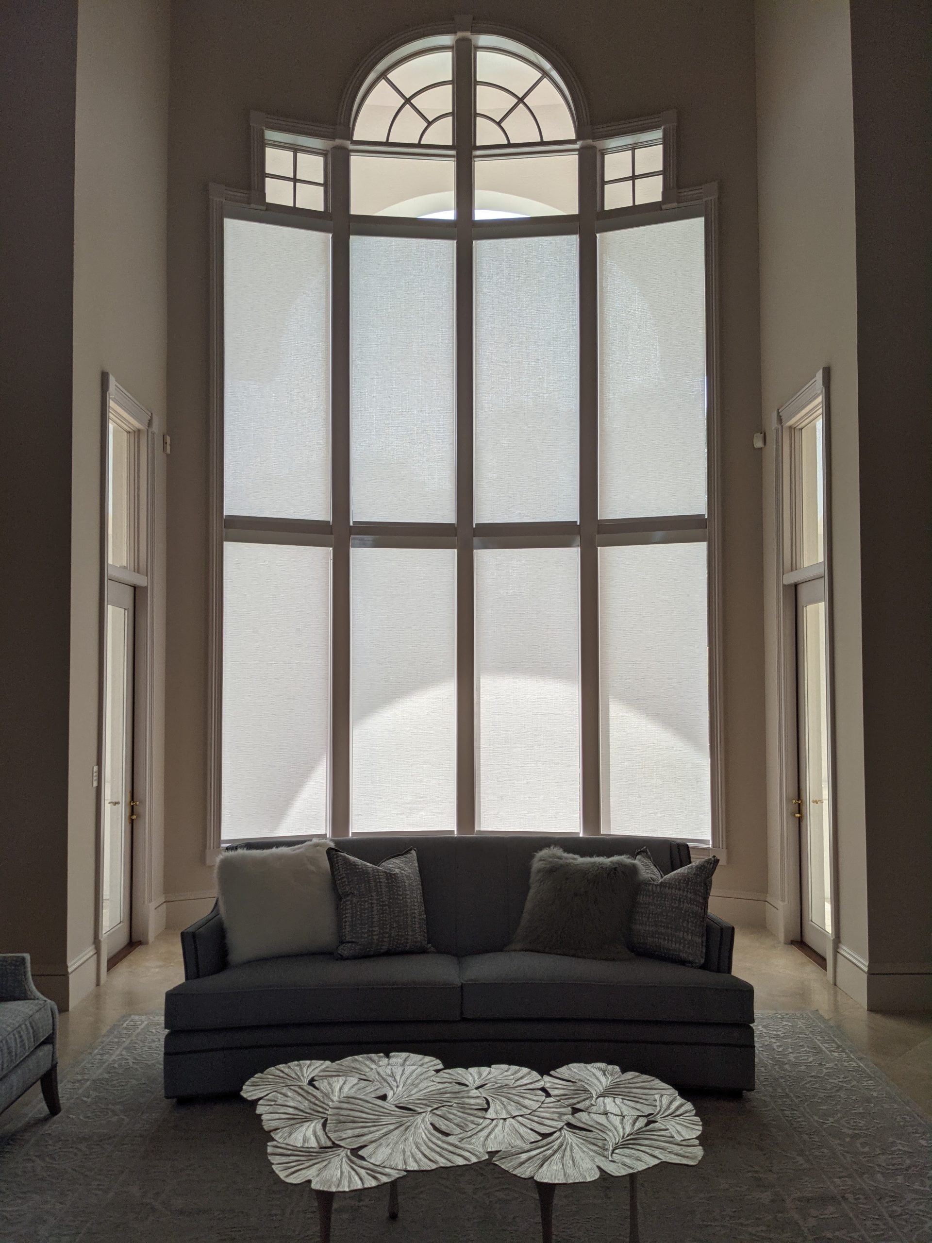 Living room with arched windows and modern furniture.