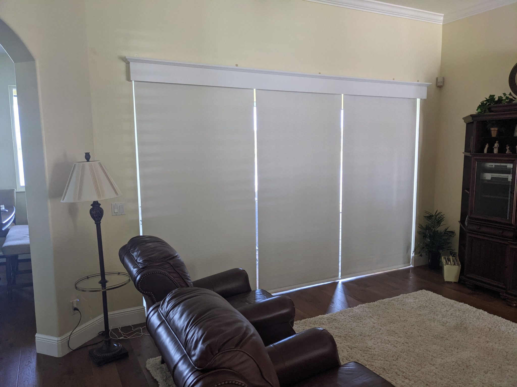 Living room with blinds and leather chairs