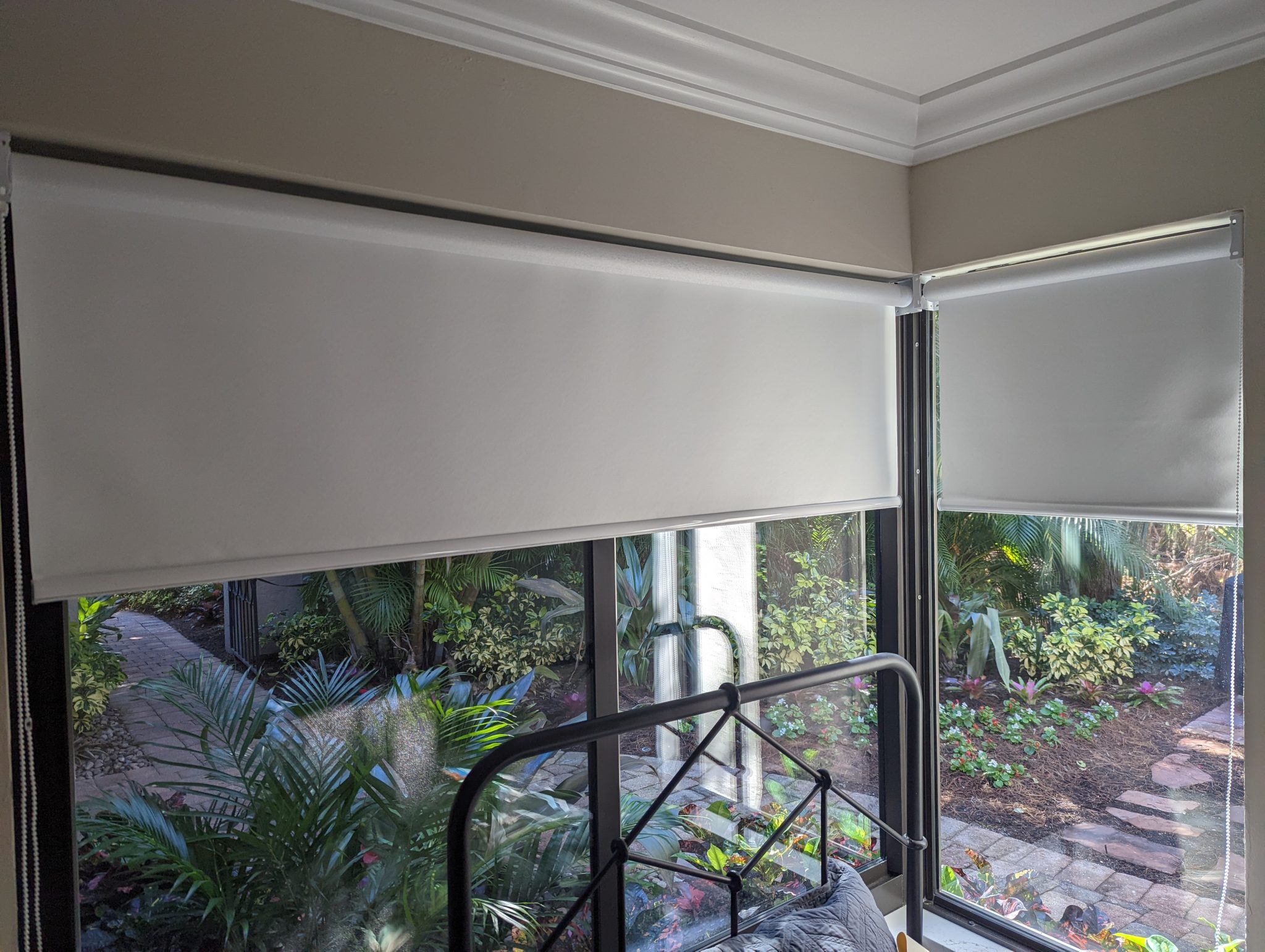 Room with garden view and roll-up blinds.