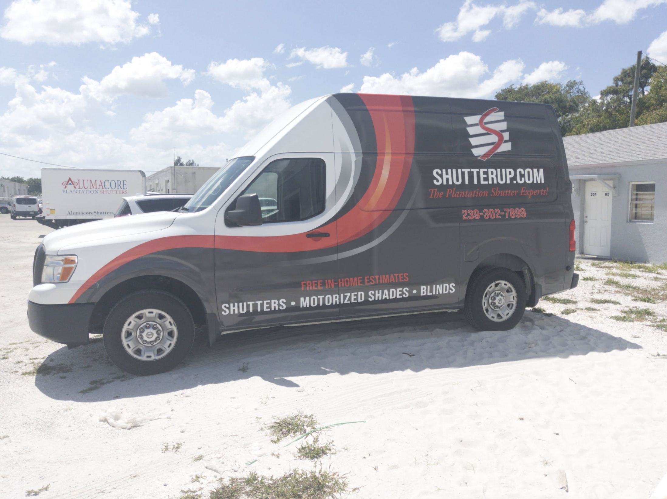 Shutter company van with contact details and services.