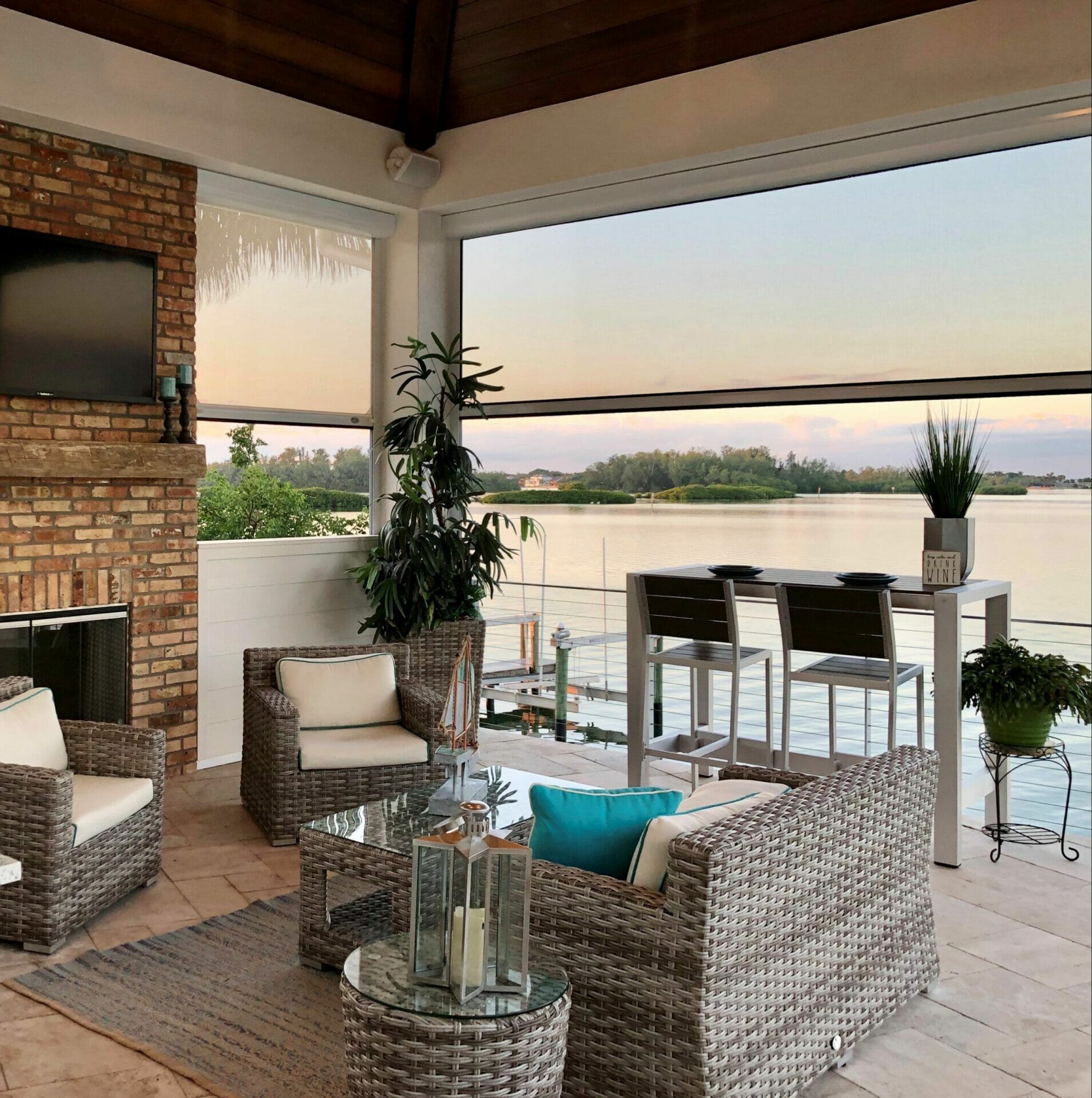 Outdoor patio overlooking serene lake view with motorized shades