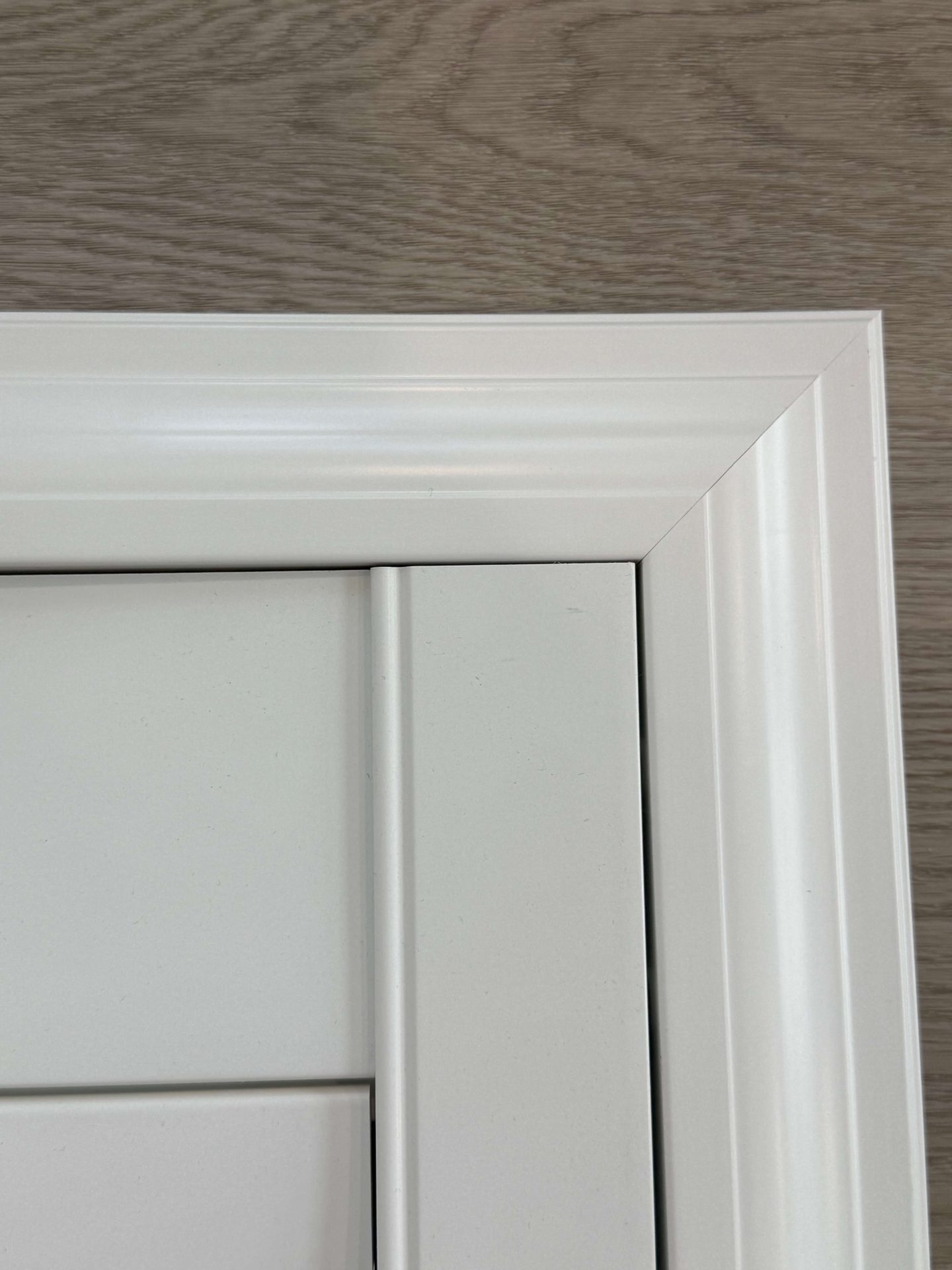 White corner door frame on wood background