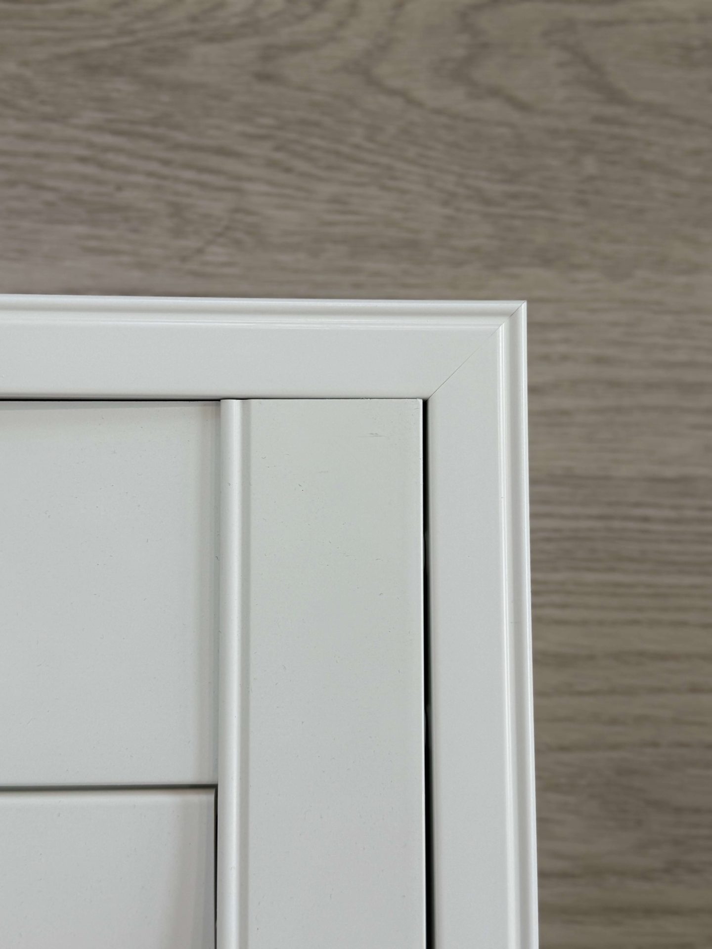 White cabinet corner on wooden background